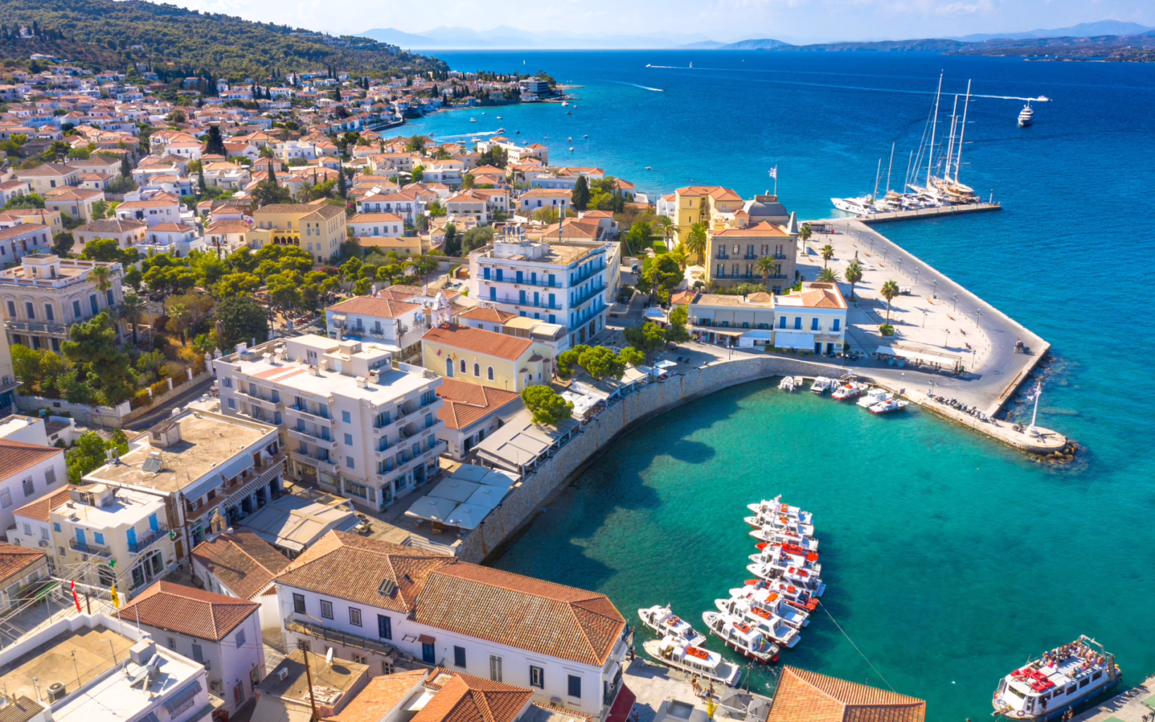 Aerial view of Spetses town and harbor with boats and turquoise water, Greece