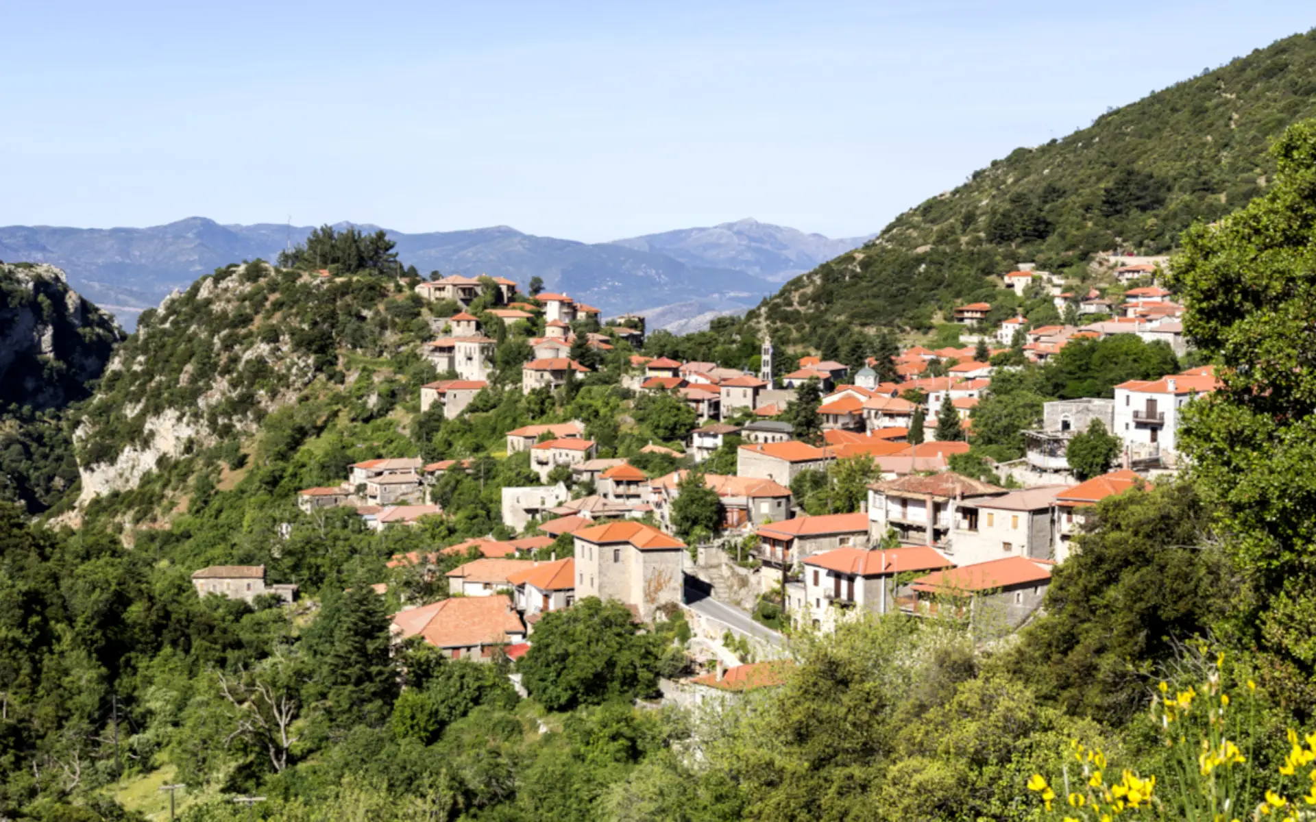 Traditional stone houses of Stemnitsa village overlooking the Arcadian mountains in Greece.