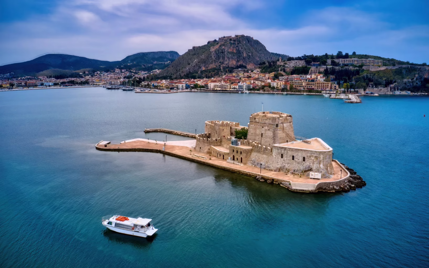 Bourtzi fortress in Nafplio harbour with the Argolic Gulf and town in the background